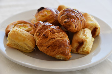 Raisin Buns and croissants on a plate