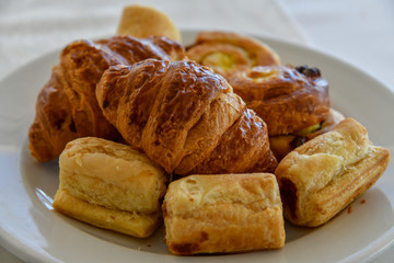 Raisin Buns and croissants on a plate