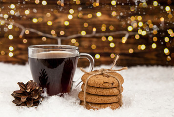Cup of coffee and American cookies on winter Christmas background