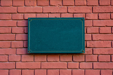 The plate is made of dark stone with an empty place for the inscription.