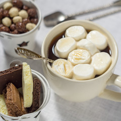 A cup of coffee with marshmallows and chocolate
