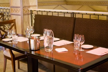wineglasses and glass jugs on a table ready for wine testing in a restaurant