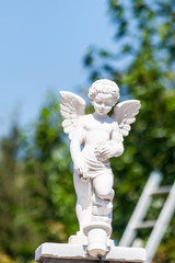 Small white stone Angel sculpture in one of the houses on the Greek island of Thassos