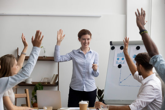 Businesspeople Voting Raise Their Hands Think The Same Way, Unanimously. Diverse Multi-ethnic Businesswomen Businessmen Gathered Together In Boardroom For Training And Business Knowledge Improvement