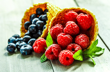 Berries in waffle cones grey background