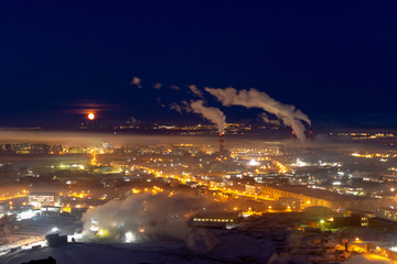 Moon over night industrial city, Norilsk