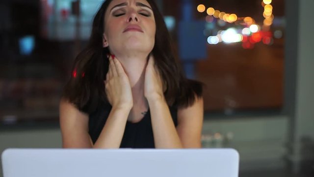 Female Manager, tired of working at laptop, sore neck.