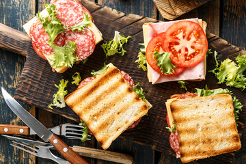 sandwiches with grilled toast ham salami cheese tomatoes and lettuce
