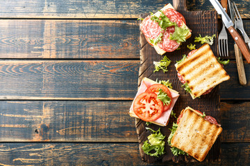 sandwiches with grilled toast ham salami cheese tomatoes and lettuce - obrazy, fototapety, plakaty