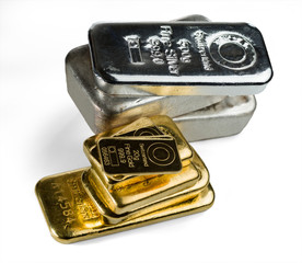 Several gold and silver bars isolated on white background. Selective focus.