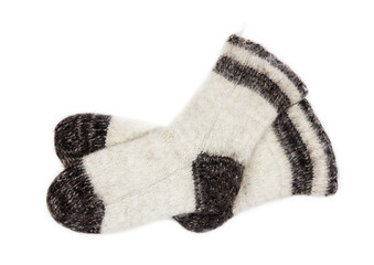 male white knitted socks of dog fur on white background close-up, top view