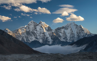 Mountain Kangtega above and below the clouds. Himalayas, Nepal - obrazy, fototapety, plakaty