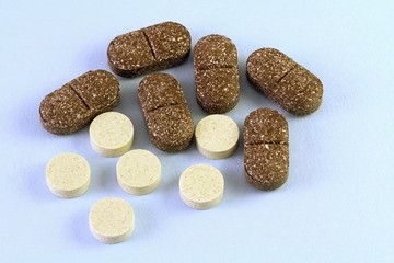 Many herbal remedy and pills on blue background. Different medicine drugs, antibiotics, vitamins. Copy space.