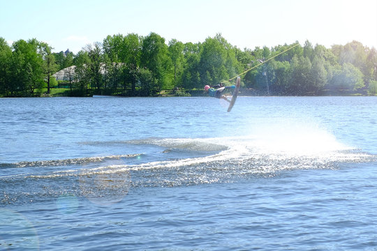 Athlete wakeboarder performs a jump with a somersault in the air - Powered by Adobe