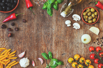 Modern composition of traditional italian food and ingredients on the vintage wooden table in the kitchen. Italian taste and look. Top view. Copy space.