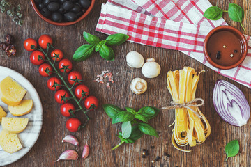 Stylish composition of fresh, italian ingredients and food on the vintage wooden table. Culinary backgrounds. Top view.