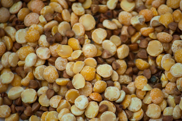 A mixture of dried cereals and legumes. Mixed peas and buckwheat. Entertaining lesson for kids. The development of fine motor skills. Go through the cereals