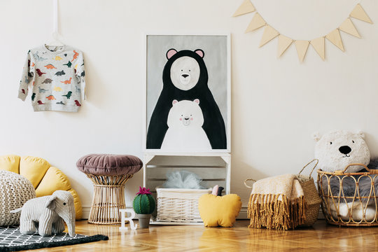 Stylish scandinavian newborn baby room with colorful toys, teddy bears, pillows and blankets. Modern interior with mock up photo frame.