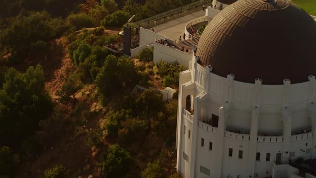 Cinematic Aerial of Griffith Observatory with  The Hollywood  Sign as background / Los Angeles, California 