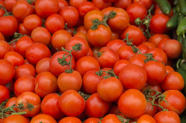 Pile of red juicy tomatoes background.
