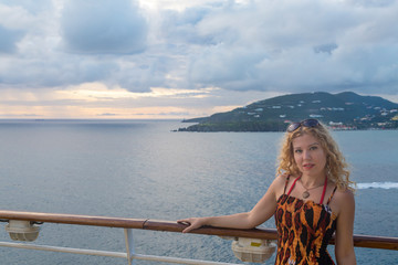 Fototapeta premium Blond woman on cruise ship with sunset view in Philipsburg, St Martin