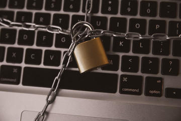 Cyber safety concept, locked chain on laptop computer keyboard