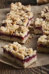 Raspberry bars on rustic wooden table