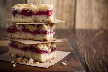 Raspberry bars on rustic wooden table