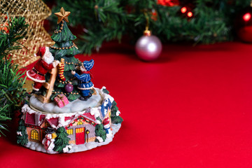 Old Christmas music box spinning, garland and tree, ornaments in background, close up