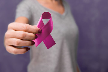 Elderly woman holding purple ribbon awareness w copy space. Symbol is used to raise awareness for...