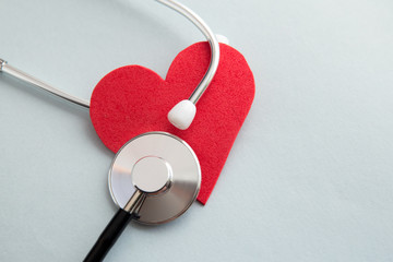 Healthcare medical insurance business and world heart health day concept with red heart and bandage...