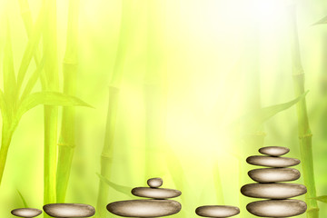 Spa still life background with zen stones and green bamboo forest. Space for text.