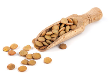 dry lentils on wooden spoon isolated on a white background