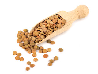 dry lentils on wooden spoon isolated on a white background
