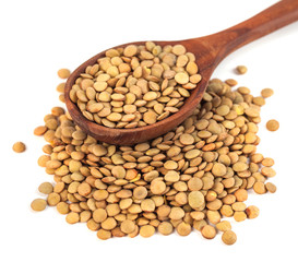 dry lentils on wooden spoon isolated on a white background