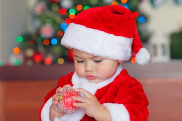Cute baby boy with Christmas bauble