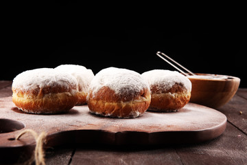 German donuts with jam and icing sugar. Carnival powdered sugar raised donuts