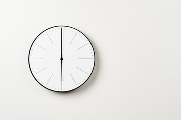 Classic round wall clock on a white background with copy space