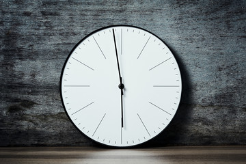 Classic round wall clock on a wooden background