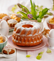 Yeast cake sprinkled with powdered sugar on the holiday table. Traditional polish easter dessert - 238091882