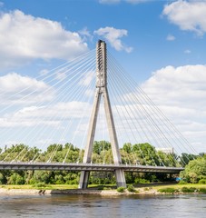 Fototapeta na wymiar The pylon of the cable-stayed cradle-system bridge on the blue sky background. Swietokrzyski bridge, Warsaw, Poland, 2018.