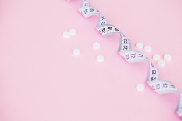 Close up of pills. Dietary supplements. Variety pills. Vitamin capsules on pink background