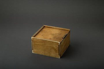 Wooden box, gift wrap, on a dark background
