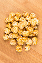Obraz na płótnie Canvas Handfuls of caramel popped popcorn kernels