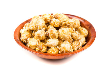 Handfuls of caramel popped popcorn kernels