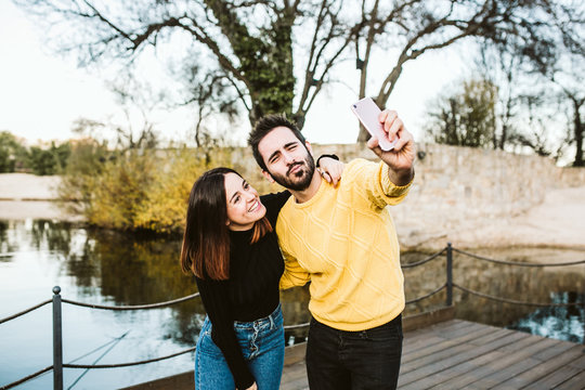 .Two friends enjoying their free time on the outdoor field. Taking some pictures of them together having fun. Lifestyle..