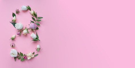 Figure 8 made of different flowers on pink background
