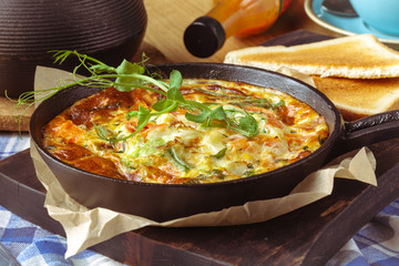 continental breakfast in a cafe, omelet with ham in pan