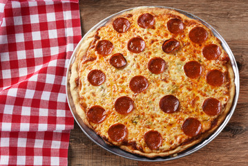 Fresh Homemade Pepproni Pizza on a red checkered table cloth