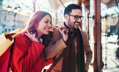 Young couple in shopping. Consumerism, love, dating, lifestyle concept